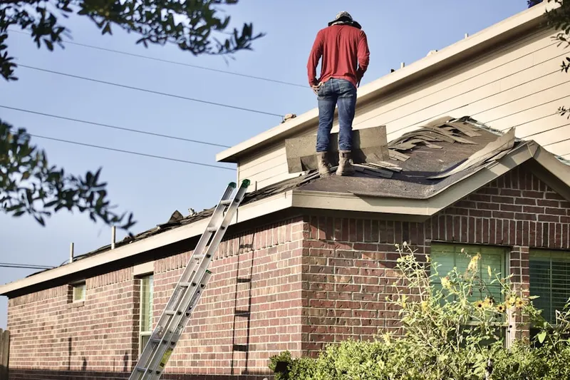 Professional roofer working on a residential roof in Castle Manor